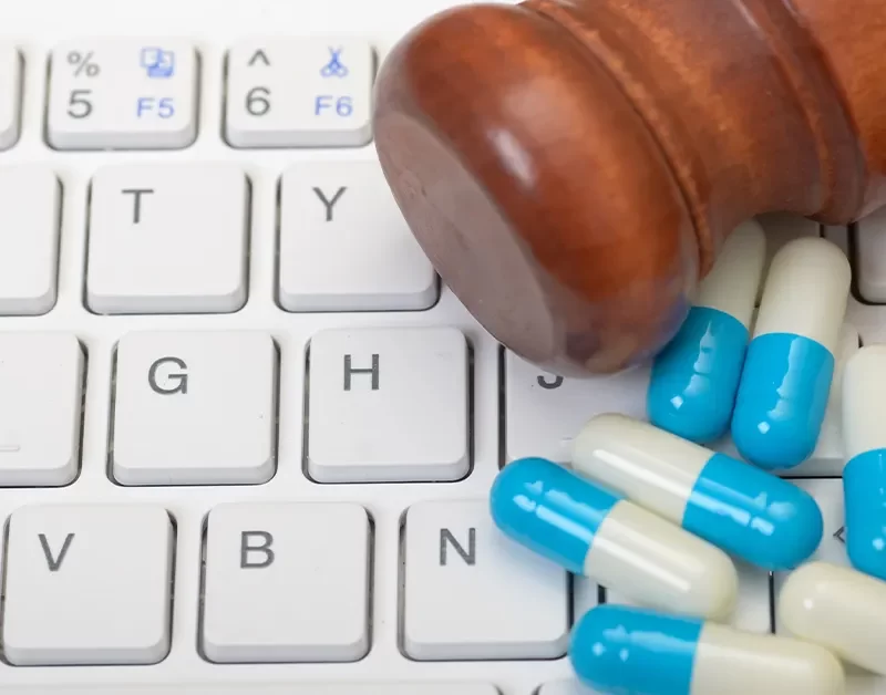 Should all drugs be legalized? Image of Gavel with pills on a computer keyboard
